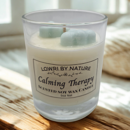Scented soy wax candle labeled 'Calming Therapy' by Lowri by Nature on a wooden surface.